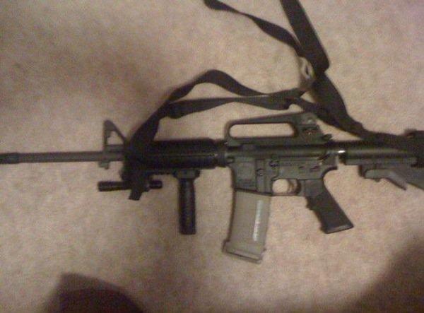 My real steel Ar15/M4, .223 caliber, 3 point tactical sling, forward handle, LED light, collapsable stock, tan PMAG 30 round magazine. I love my baby!